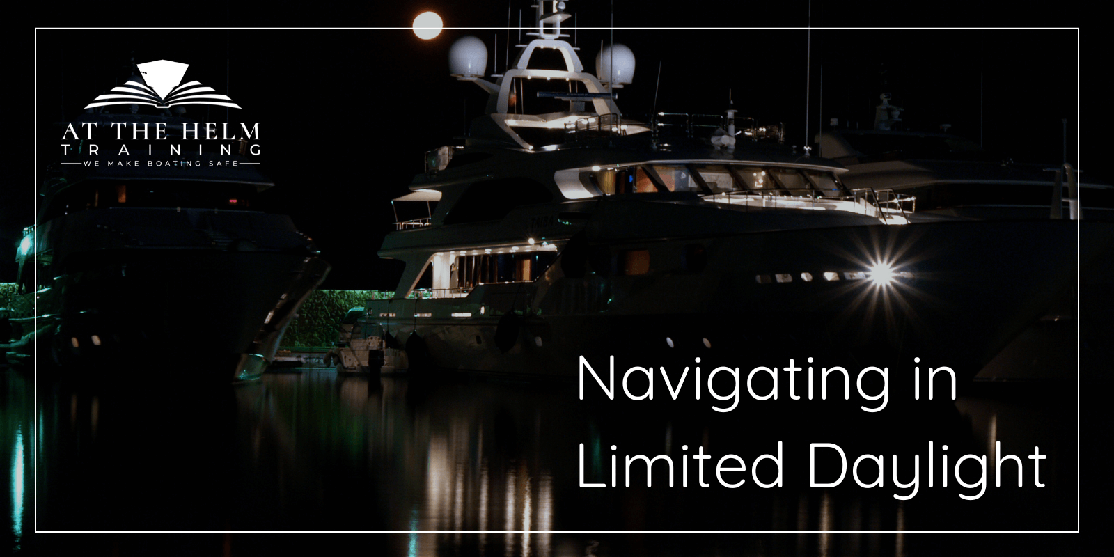 A large yacht in a harbor at night with navigational lights on. 